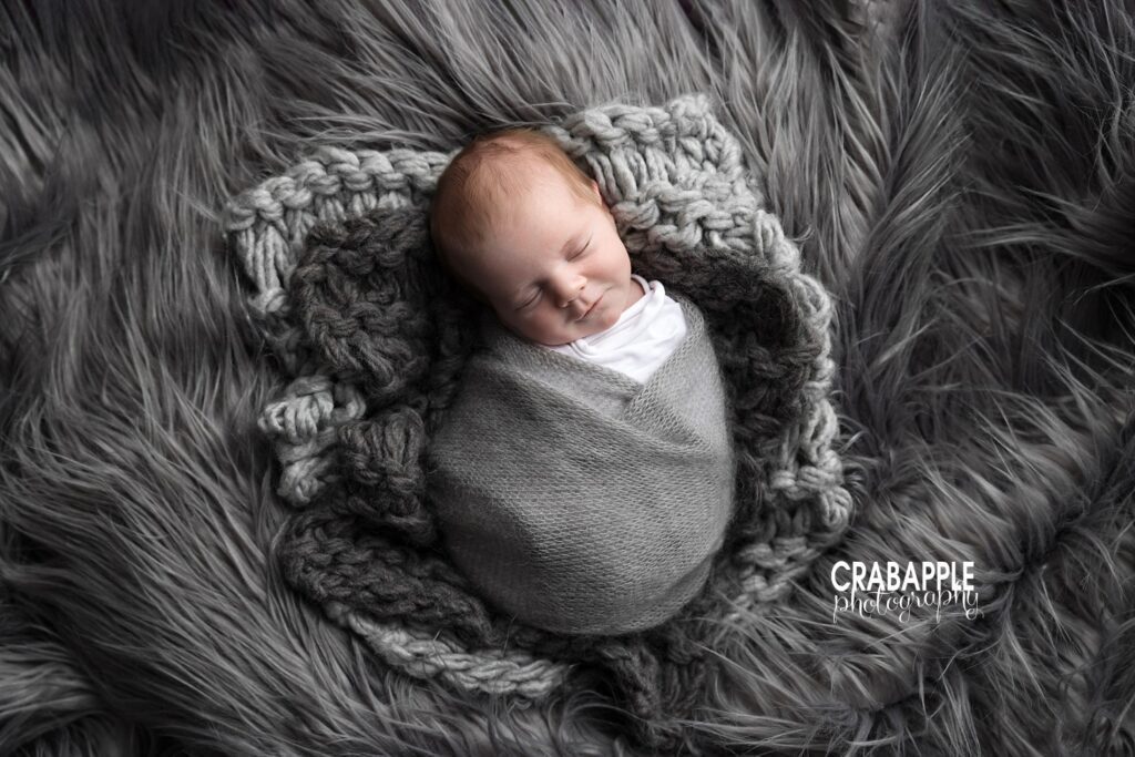 Newborn wrapped in gray blanket on matching gray fur backdrop | Andover MA newborn photographer
