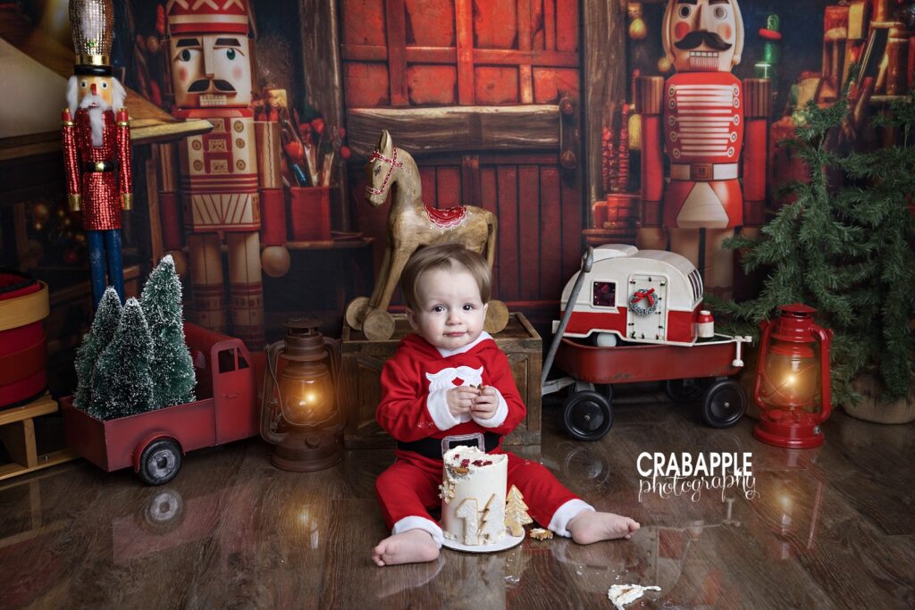 1-year-old smashing Christmas cake in festive Santa outfit
