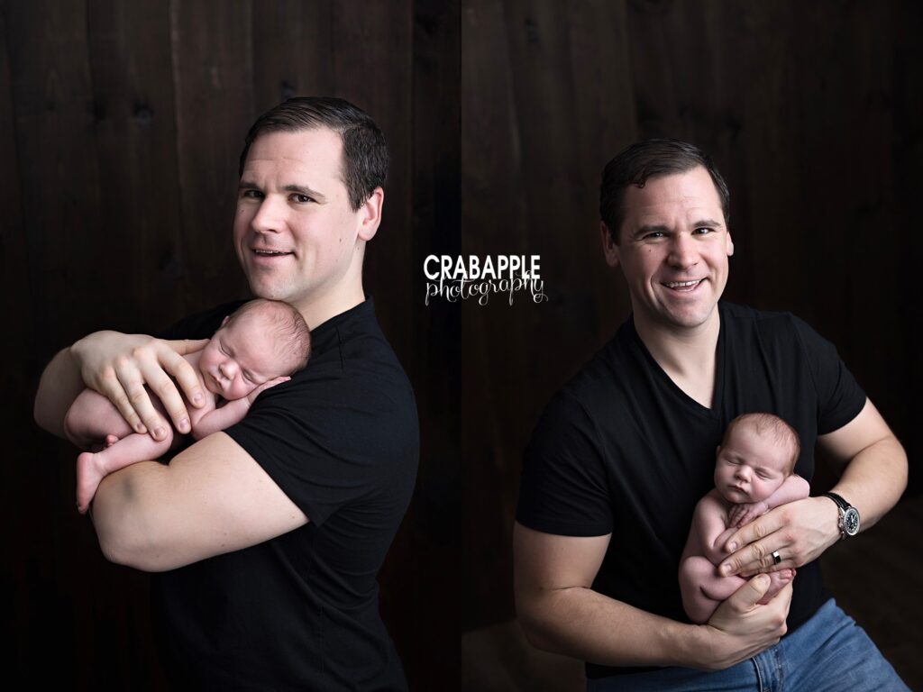 Father holding newborn baby close on black backdrop | Studio newborn photography Andover
