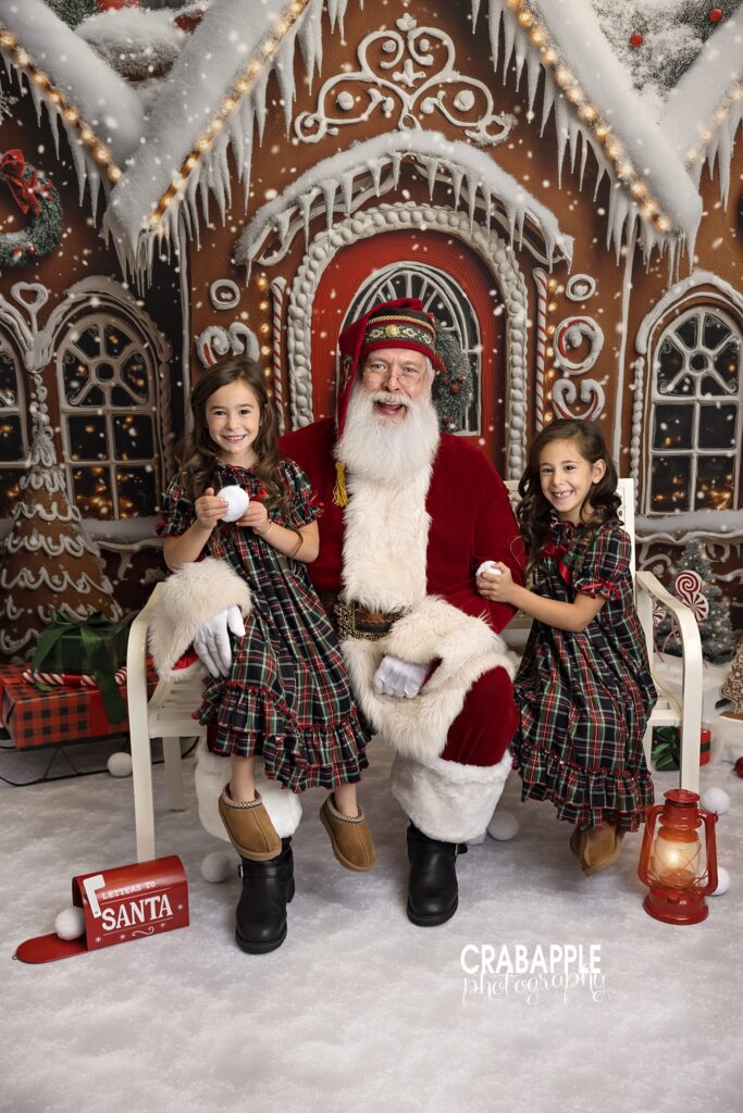 Santa smiling with two sisters during Christmas mini session North of Boston
