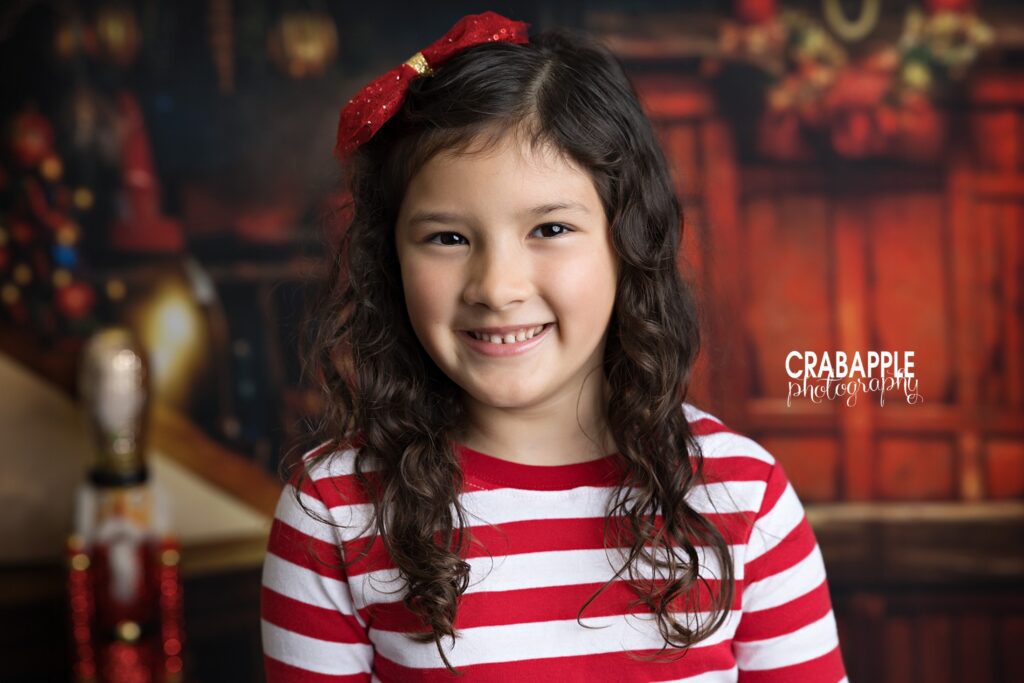 Close up Christmas studio portrait of girl wearing red and white holiday pajamas