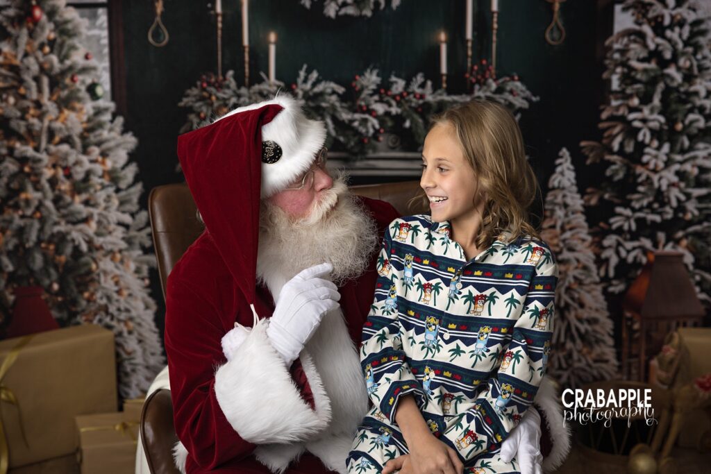 Santa talks to smiling boy during Christmas photos near Somerville MA