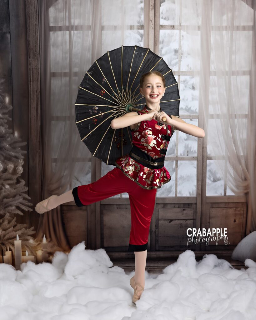 Ballet dancer practicing line work in holiday-themed portrait
