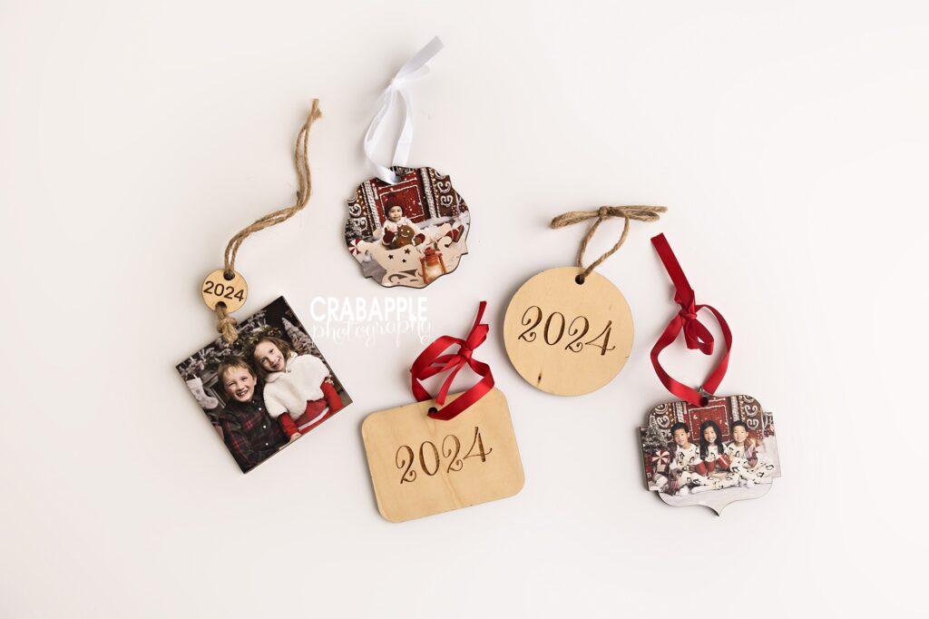 Variety of wooden Christmas photo ornaments for Santa keepsakes Five wooden Christmas photo ornaments in assorted shapes and ribbon colors, ideal for Santa photo keepsakes and Christmas photo ornaments.