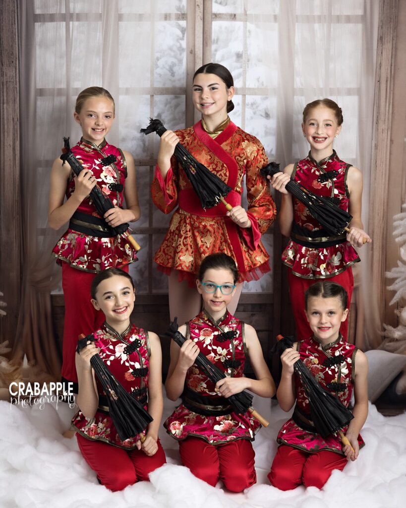 Group of dancers posing together on winter window backdrop

