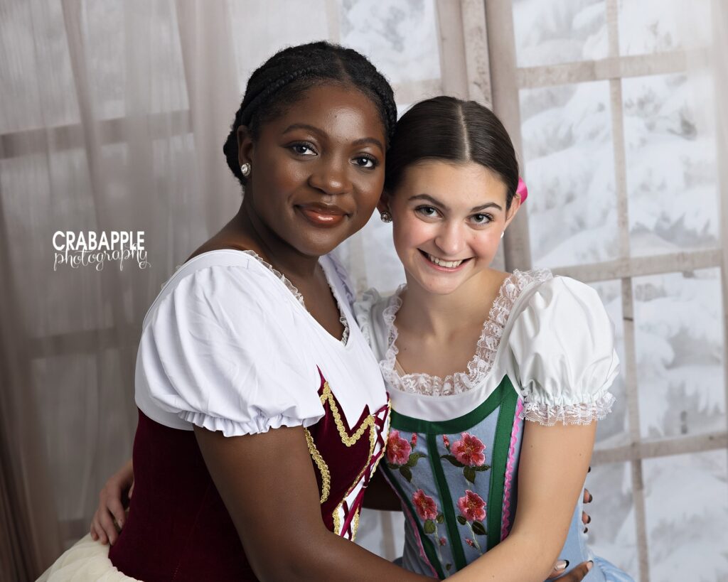 Two friends smile together during holiday mini sessions for the North Andover MA dance studio