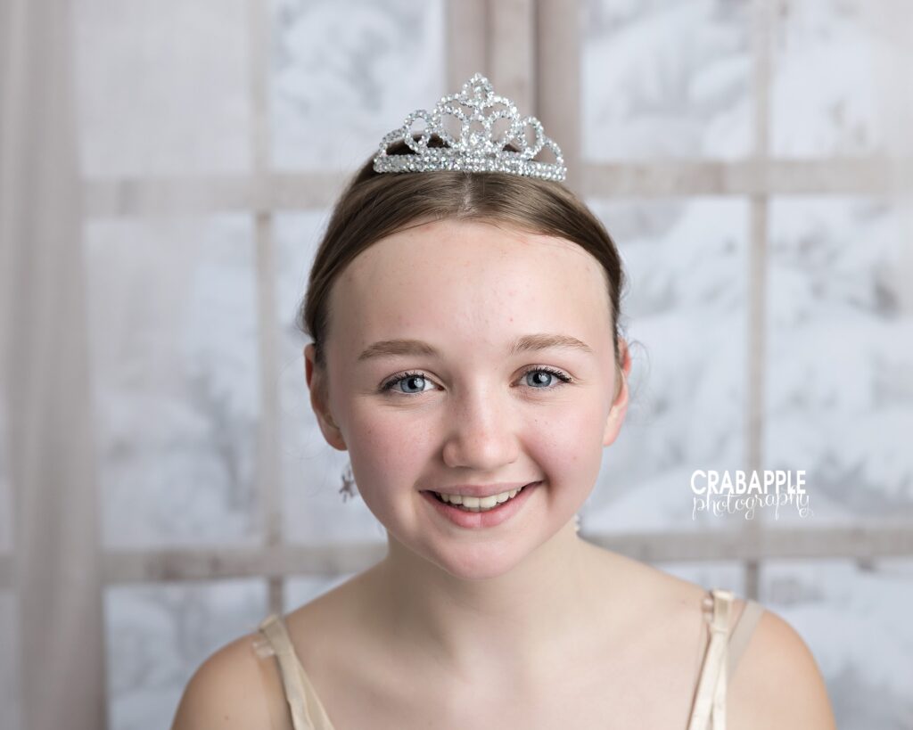 Clean studio headshot of dancer with tiara and costume
