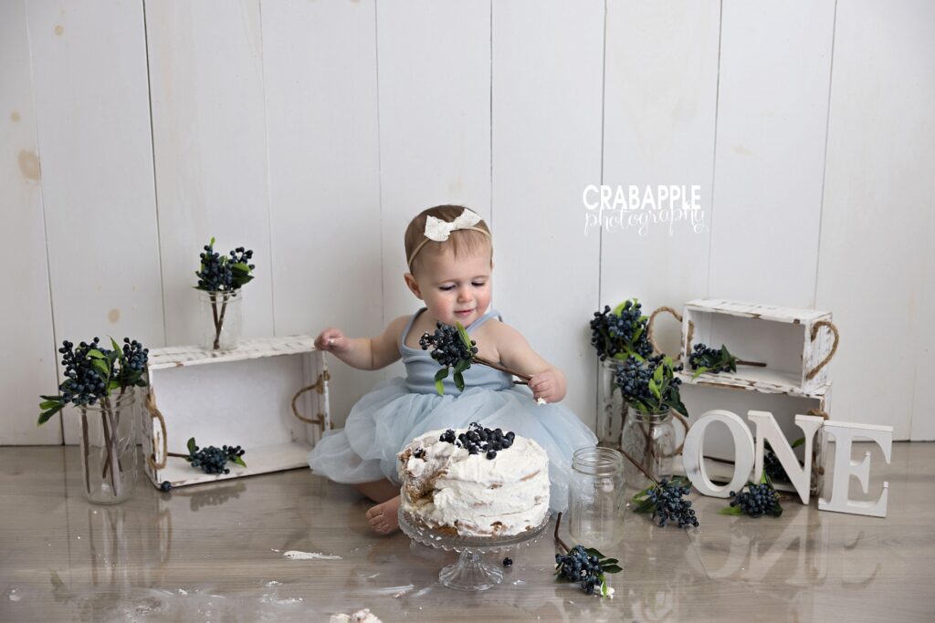 Natural cake smash baby pictures Natural cake smash baby pictures showing baby exploring cake at her own pace