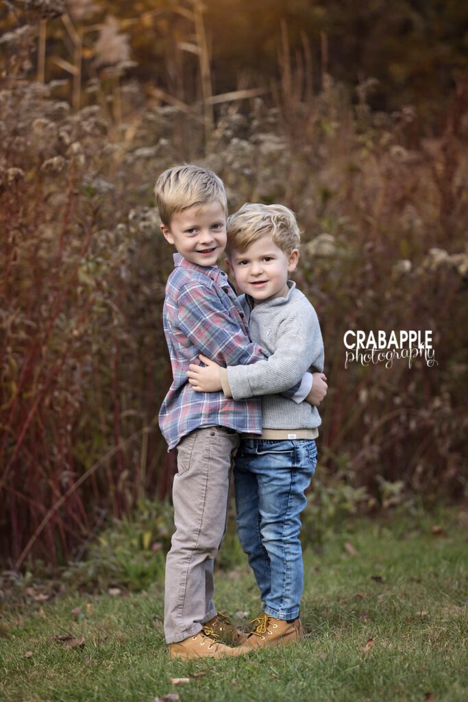 Two brothers hugging during outdoor family photo session
