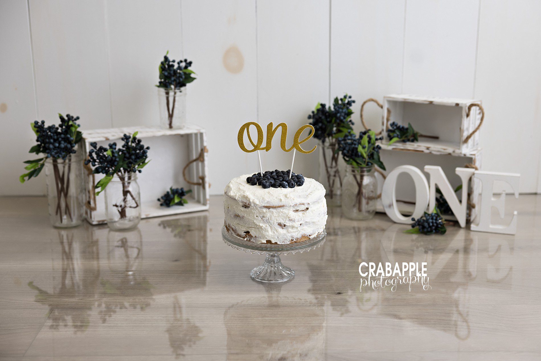 First birthday cake smash baby pictures First birthday baby pictures featuring a simple blueberry cake smash setup