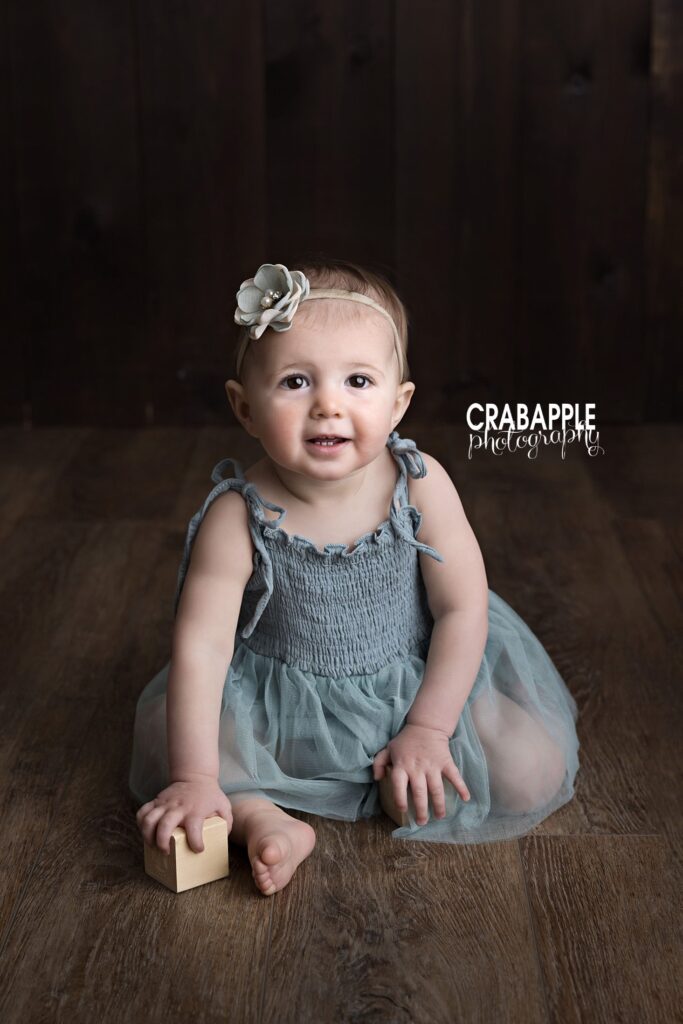 Baby milestone pictures with natural connection Baby pictures focused on connection and expression during milestone session in Andover MA