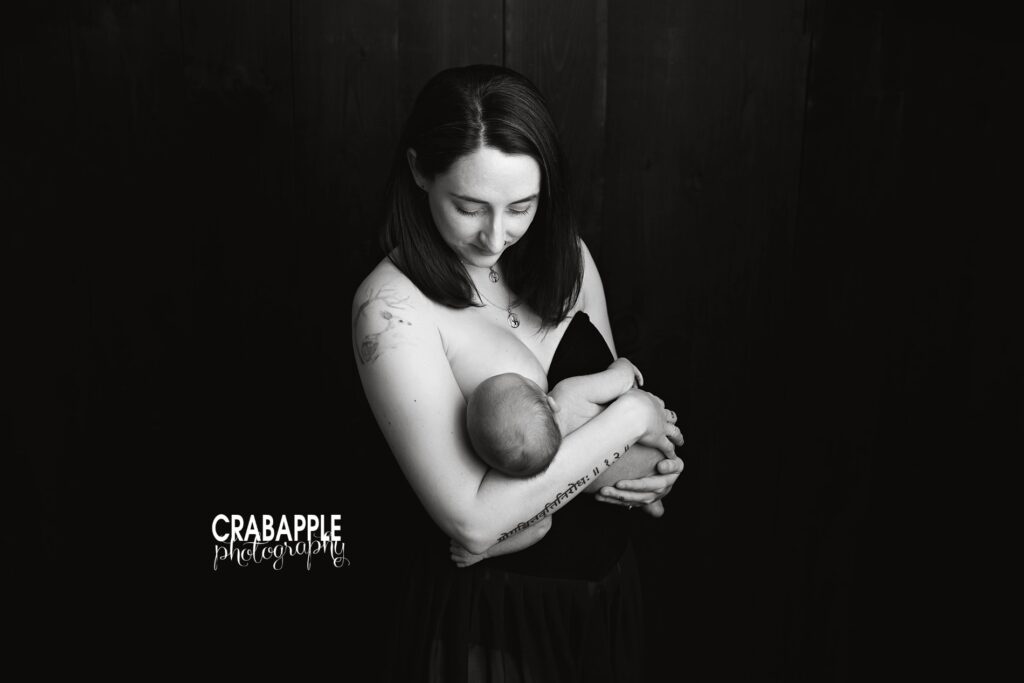Breastfeeding Newborn Baby Photoshoot in Studio Mother breastfeeding her newborn baby during an intimate newborn baby photoshoot