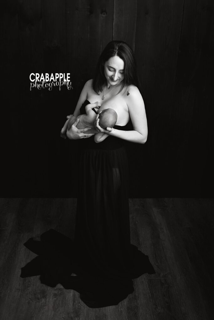 Loving newborn portraits with mother breastfeeding Black and white portrait of a mother lovingly breastfeeding her newborn during an in-studio photography session north of Boston