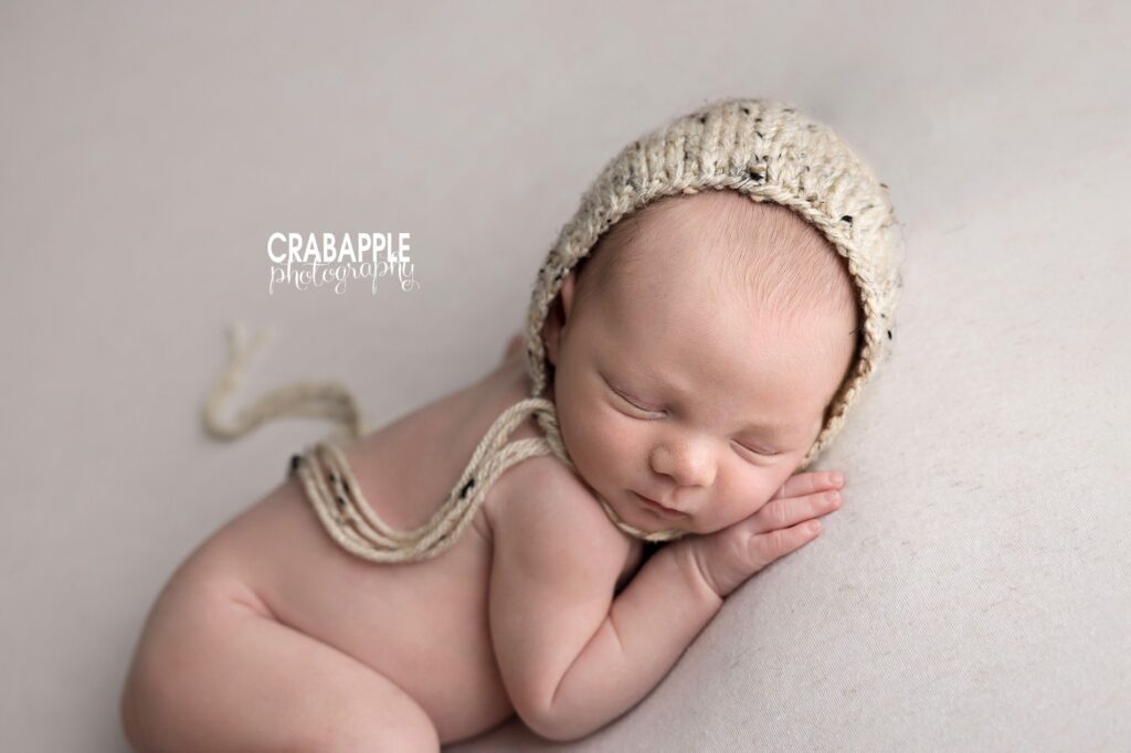 Chunky knit hat newborn baby photoshoot Newborn wearing a chunky knit hat during a brown neutral newborn baby photoshoot