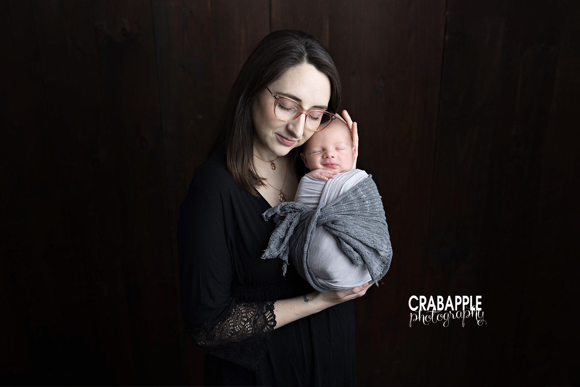 Mom and Baby Newborn Baby Photoshoot Portrait Mother holding her newborn baby during a natural newborn baby photoshoot