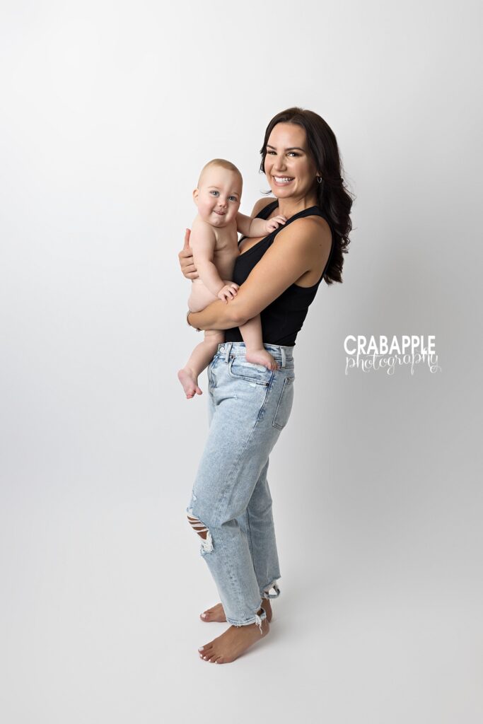 Mother and baby studio portrait during milestone photoshoot
