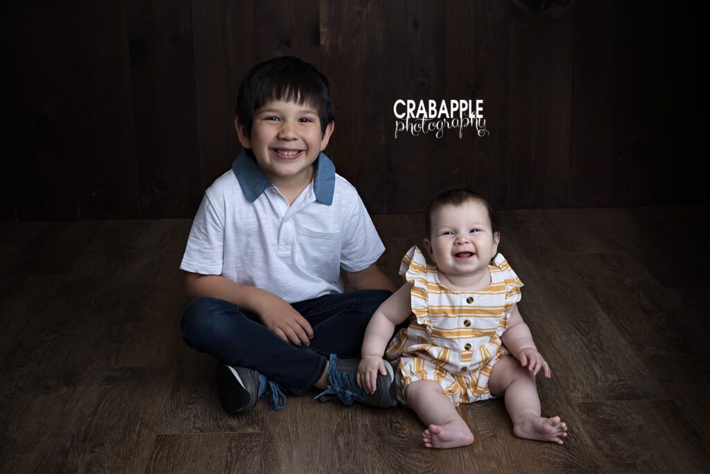 Baby girl pictures with big brother showing sibling connection during a Newton MA studio session