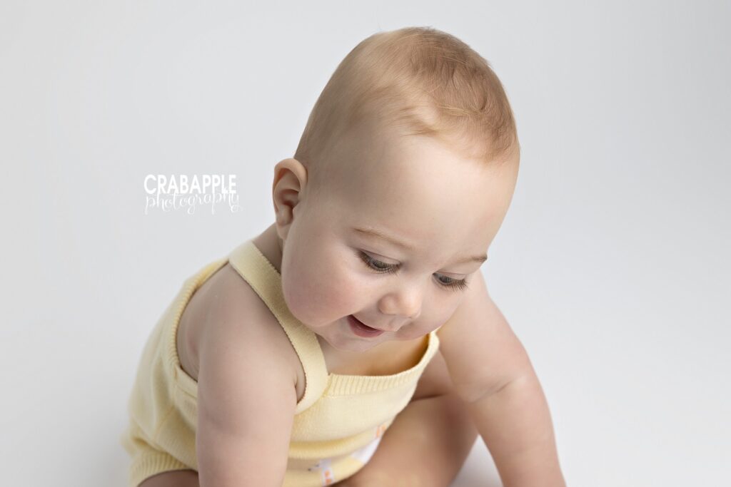 9 month baby photoshoot with light studio backdrop
