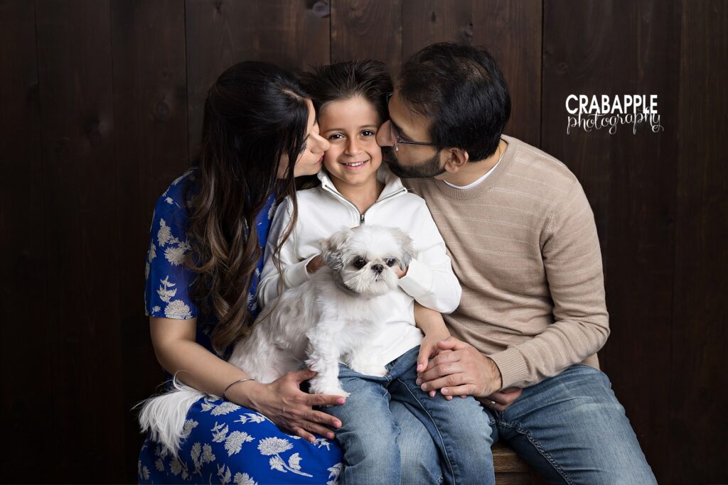 Parents and child snuggled together during intimate family photos in Reading MA

