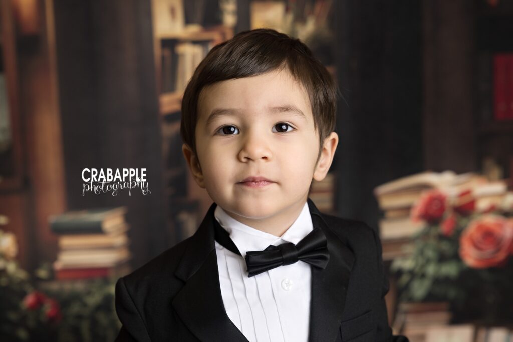 Solo portrait of a young boy in a suit and bowtie during Valentine's Day mini session
