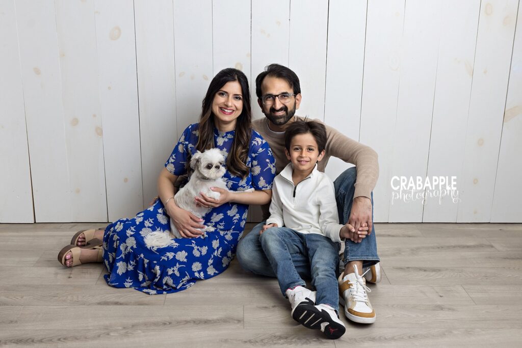Family sitting together with their dog during cozy family photos in Reading MA
