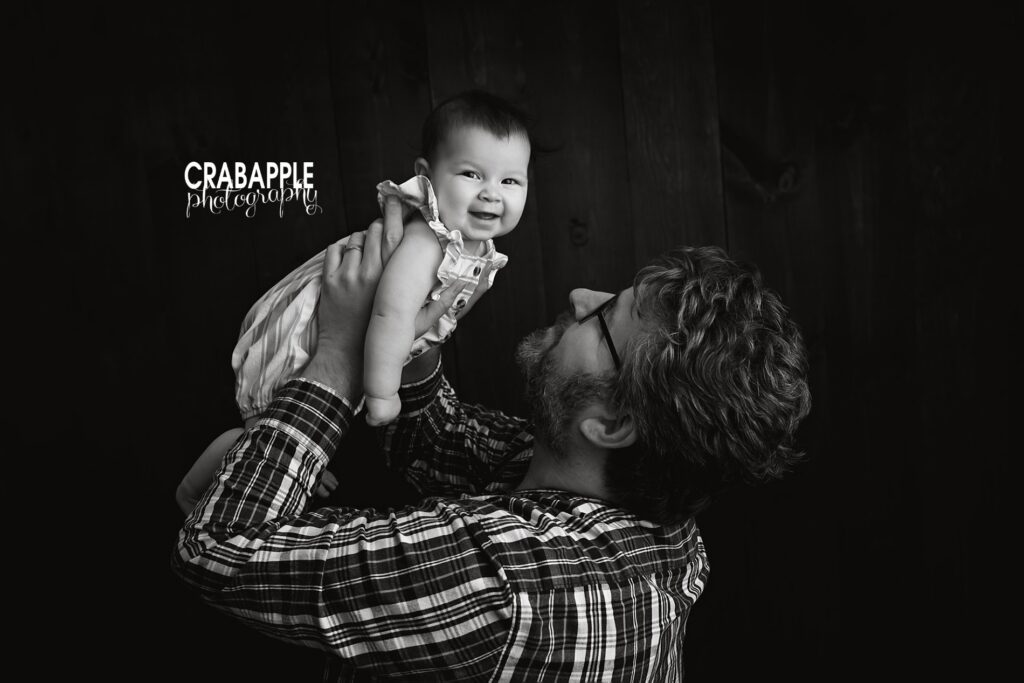 Black and white father daughter photo during 6 month old baby and family portrait session near Newton MA