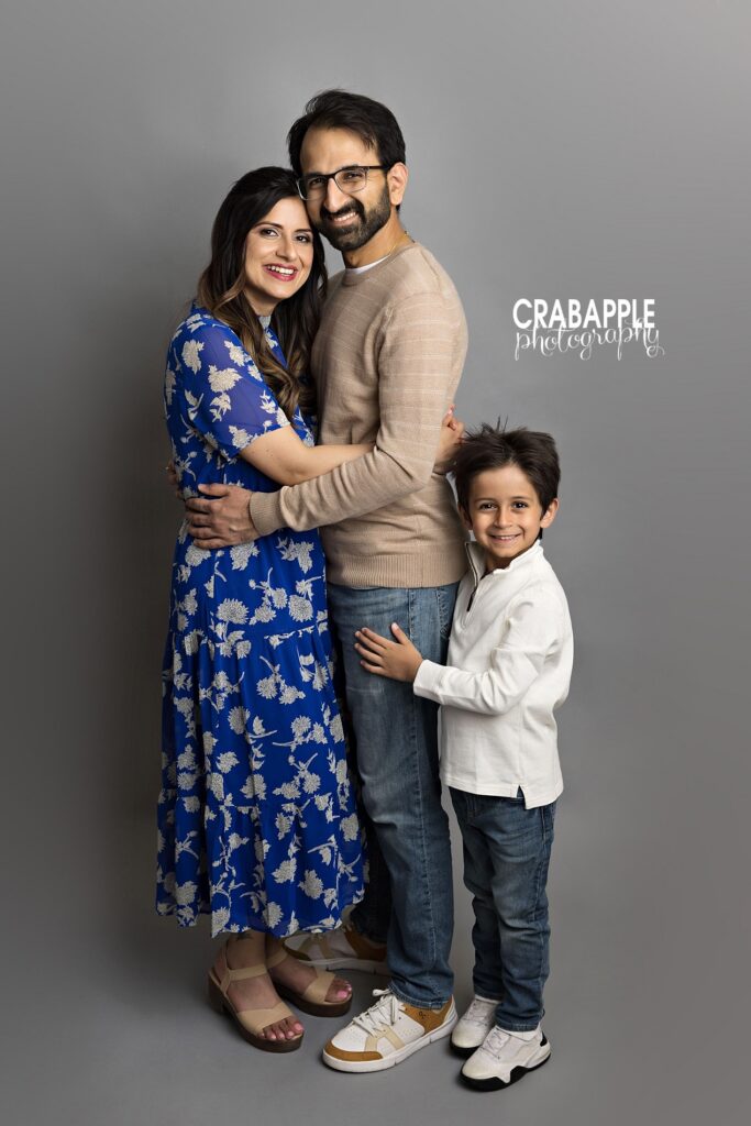 Family standing together during a relaxed family photos session in Reading MA studio
