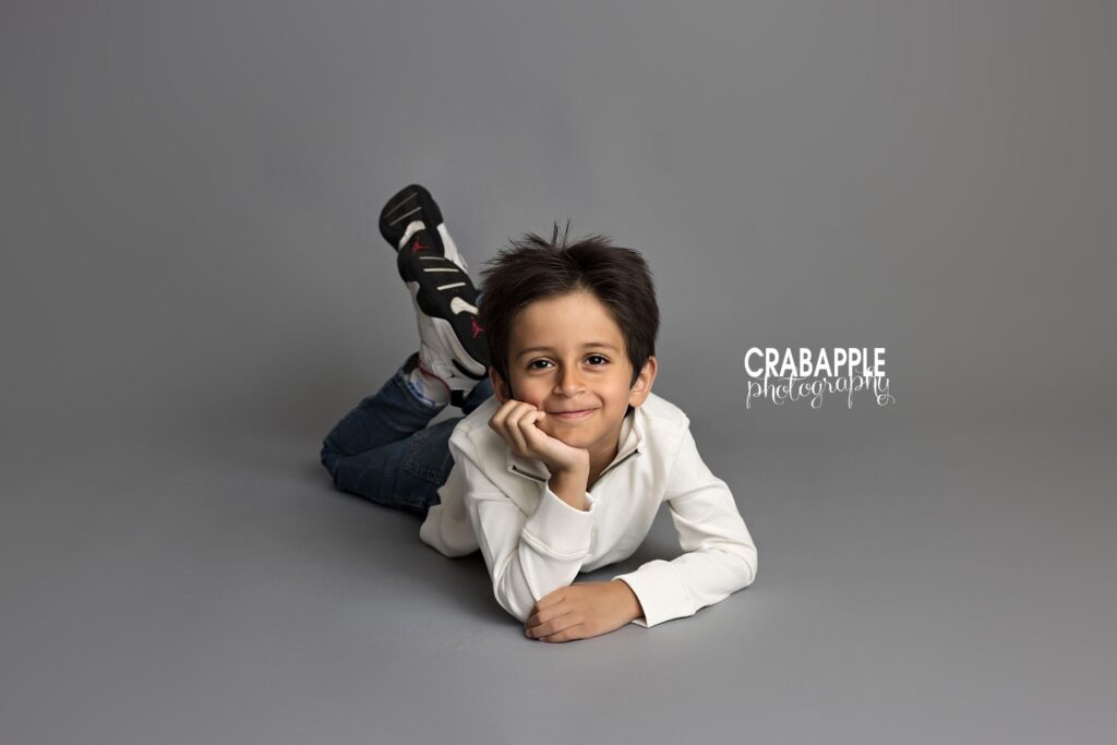 Five year old boy resting comfortably during natural family photos in Reading MA
