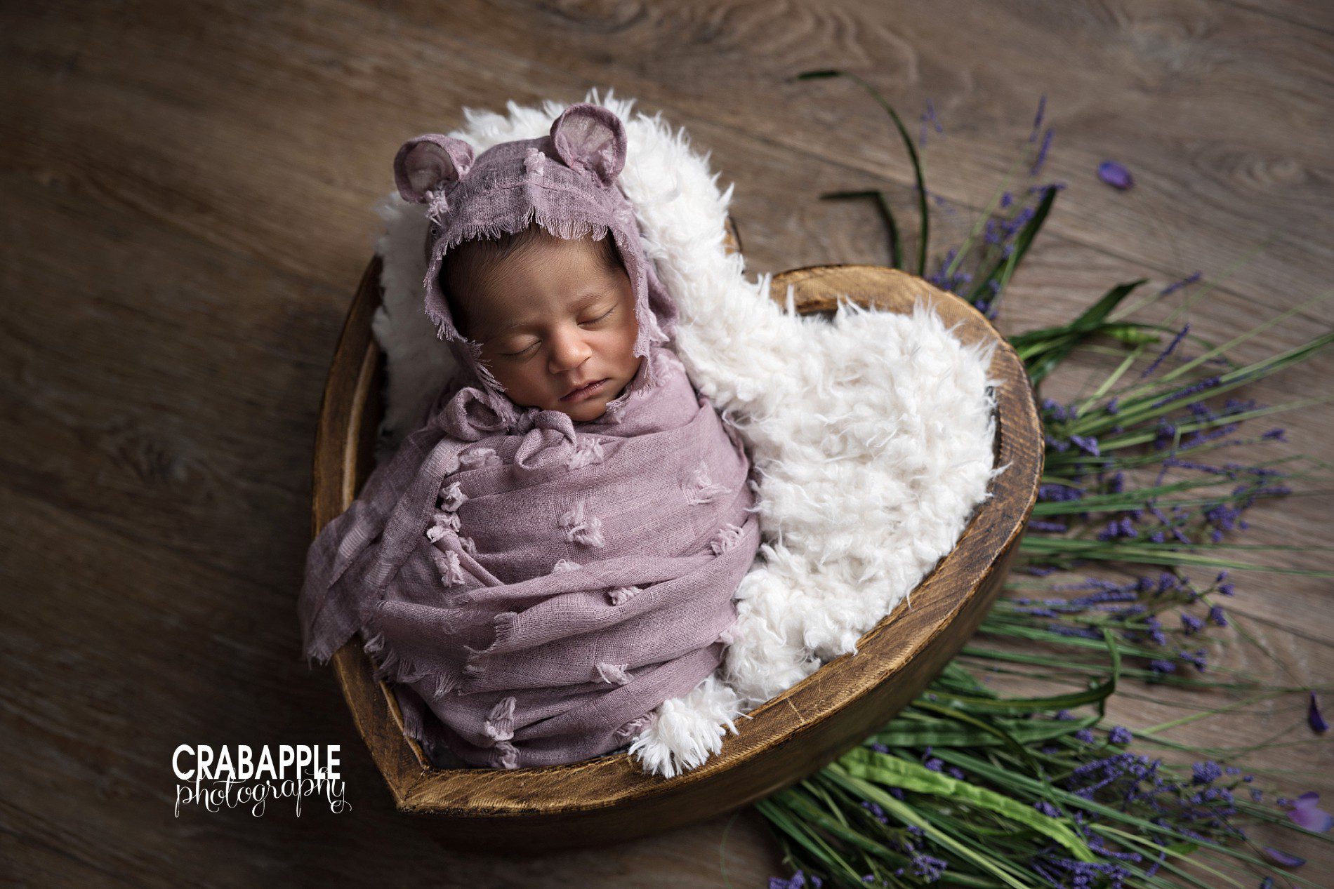 Using purple, floral, and greenery in newborn photos