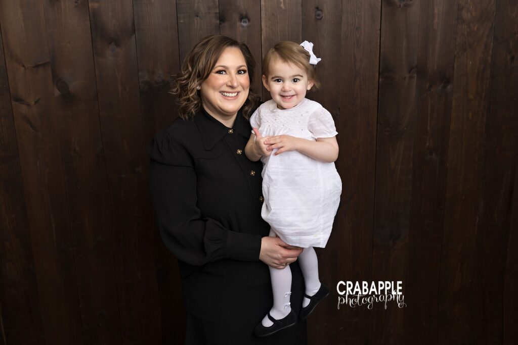 Mother holding her two year old daughter during a studio portrait session

