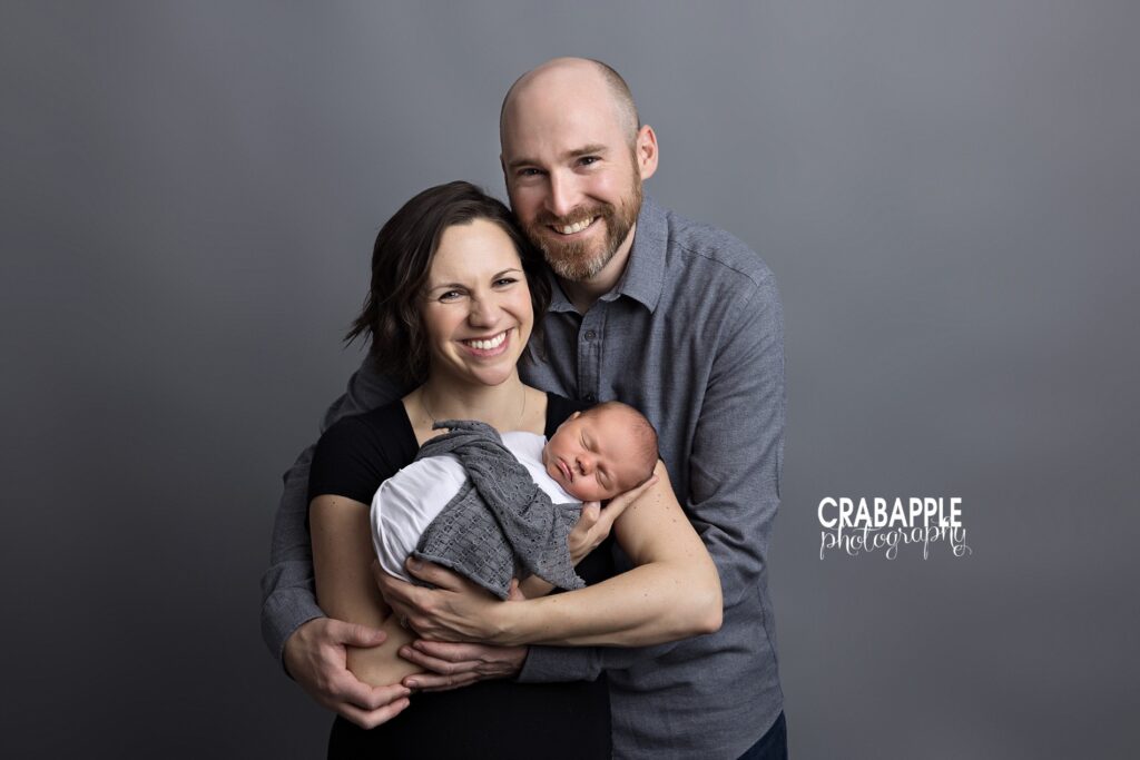Timeless newborn pictures of a family together in a Littleton MA studio

