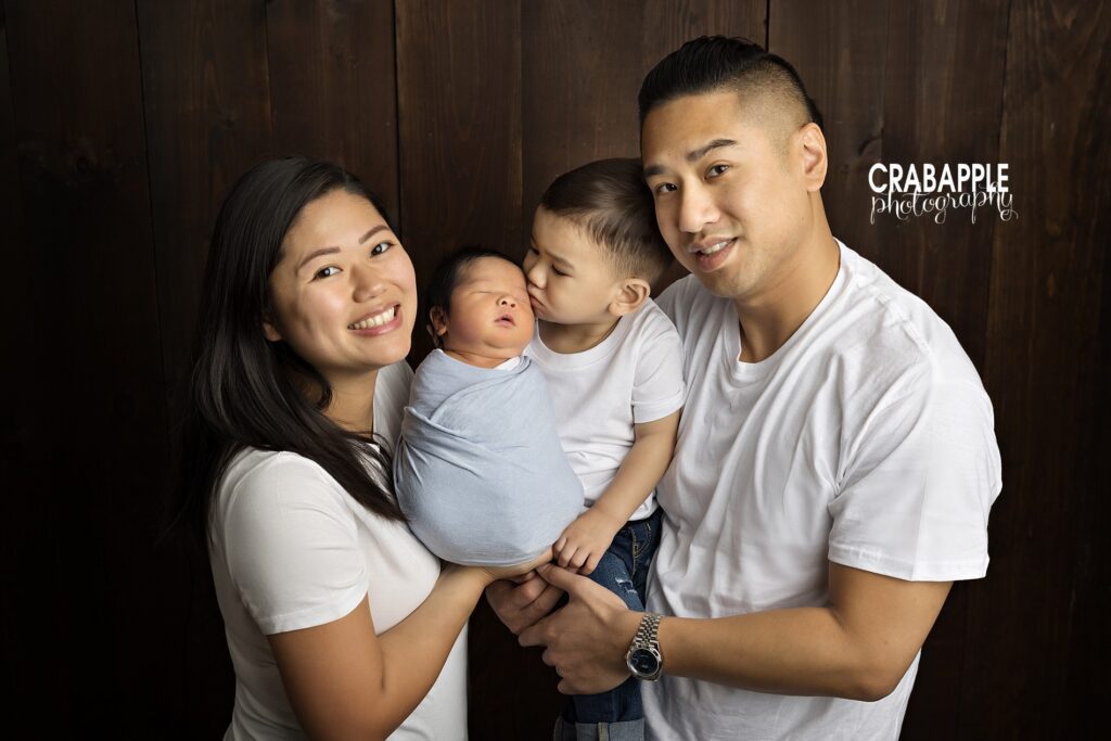 Family portrait during a newborn photoshoot in Quincy MA featuring baby boy with parents

