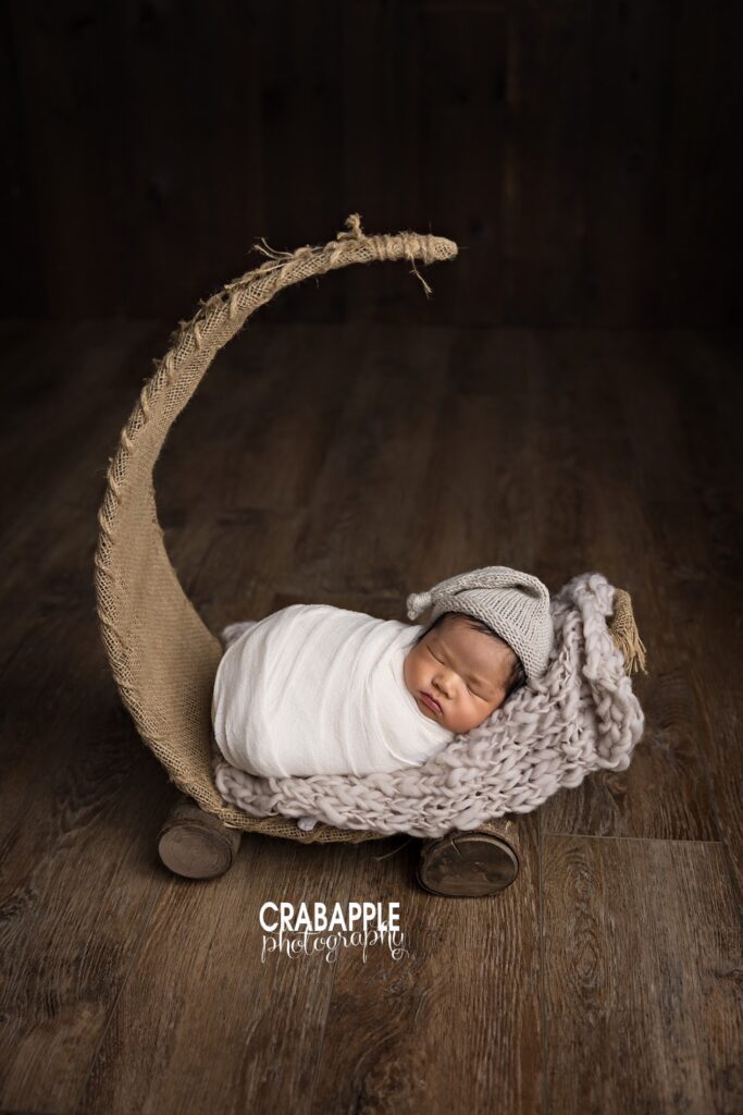 Newborn baby boy posed on a moon bed during a Quincy MA studio newborn photoshoot
