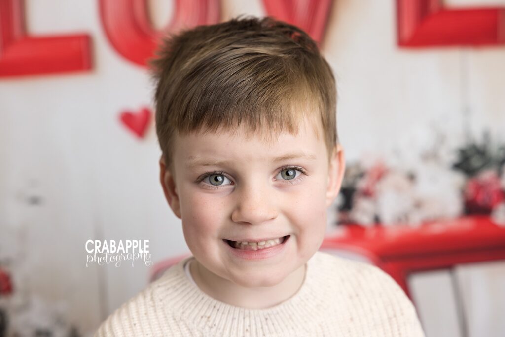 Smiling portrait of a young boy during Valentine's Day mini sessions