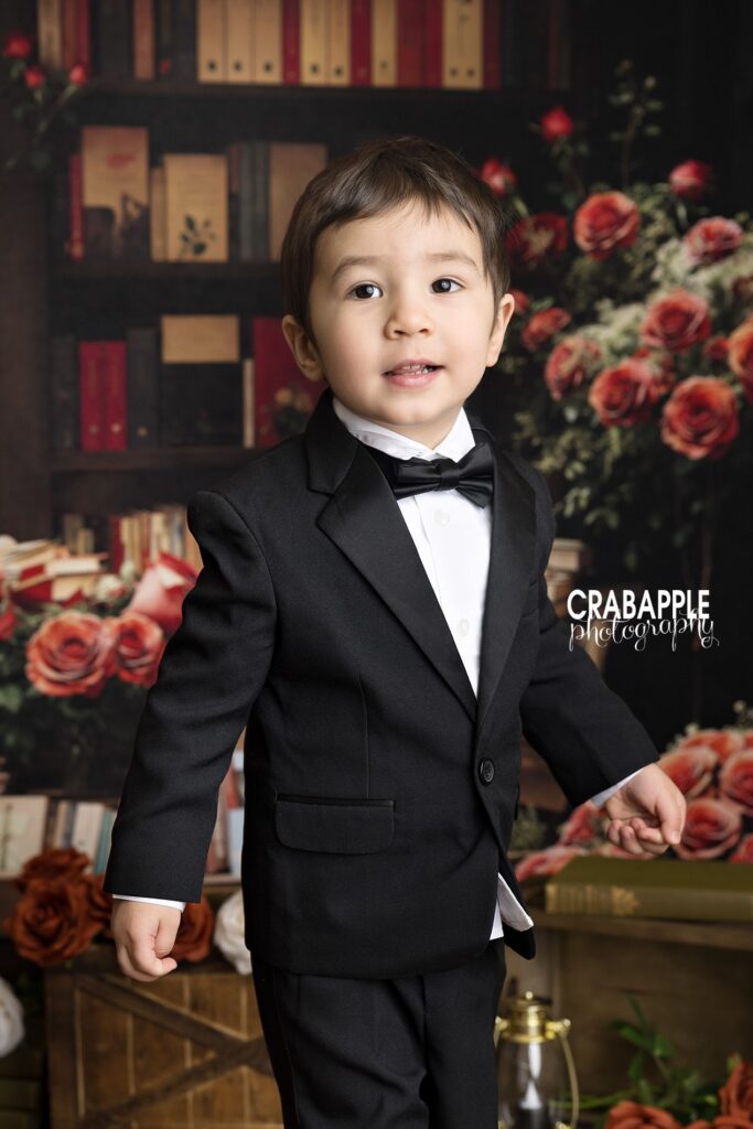 Smiling child surrounded by heart-themed decor during Valentine’s Day portraits