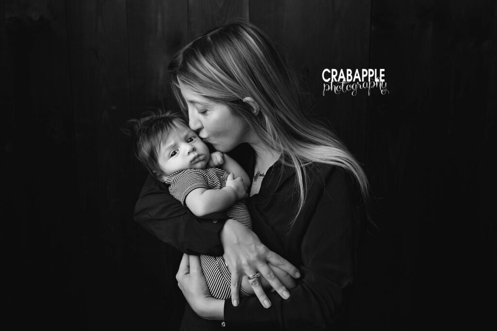 Mother holding her baby during a 3 month baby photoshoot in Dracut MA studio
