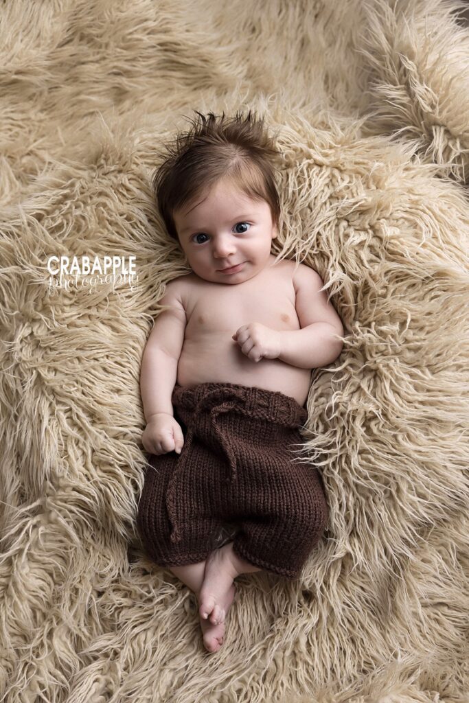 Baby lying on soft textures during a natural 3 month baby photoshoot
