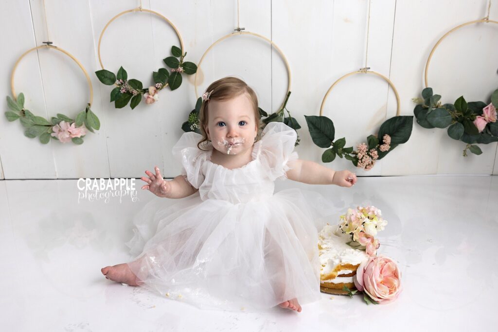 soft light baby girl cake smash photography

