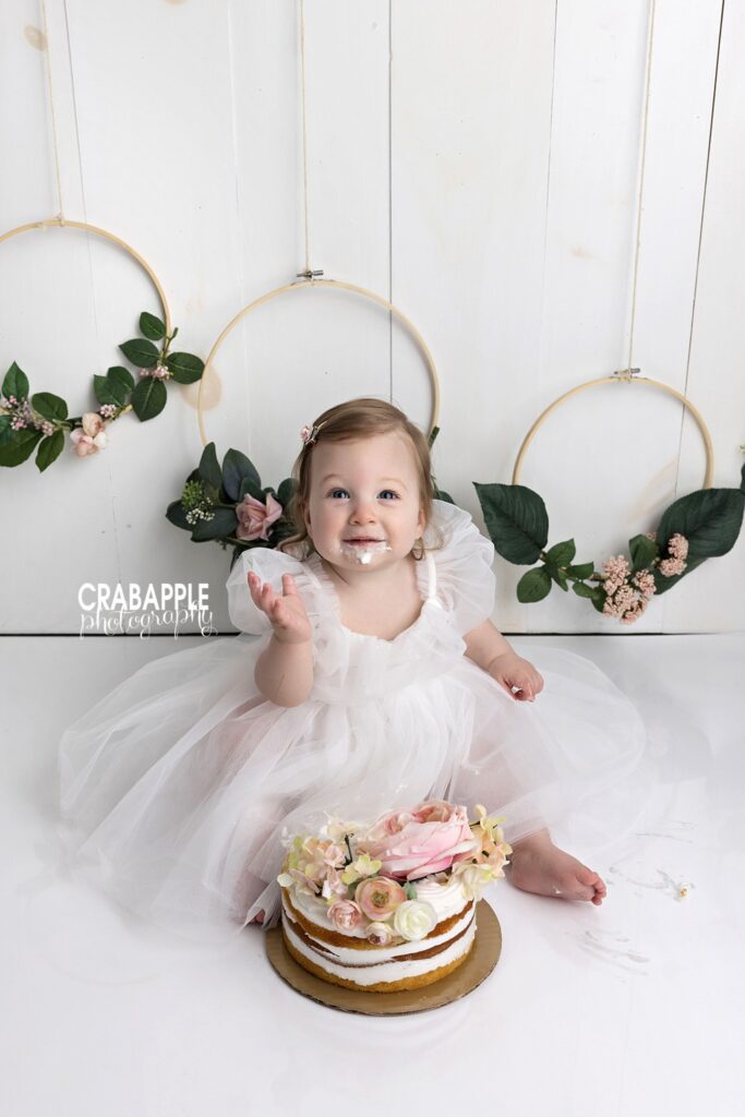 smiling baby girl during cake smash session
