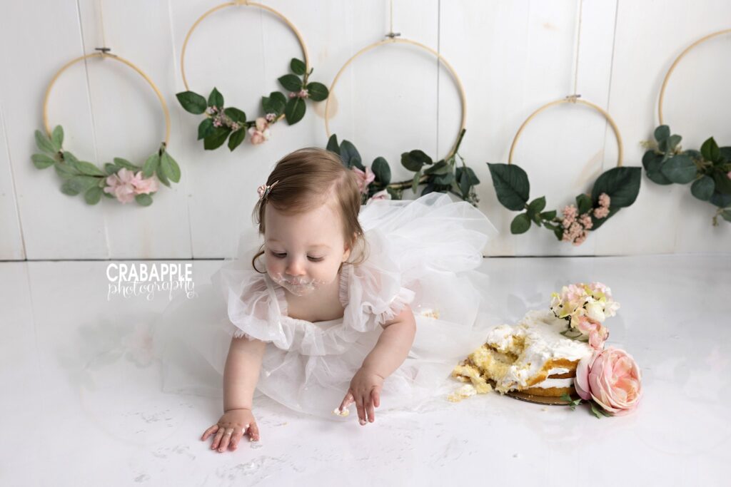baby girl crawling during cake 