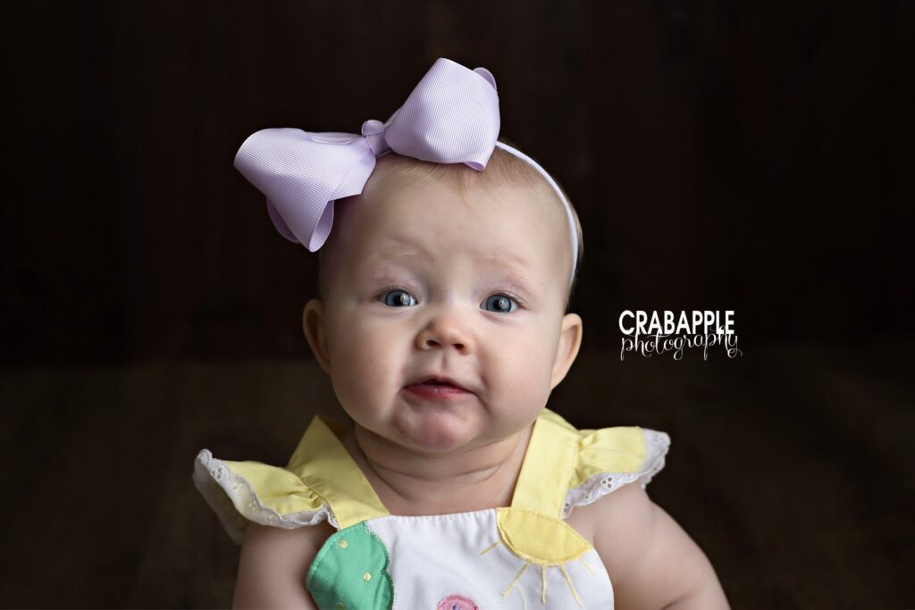 joyful baby milestone portrait session Close up baby portrait of 8 month old baby girl