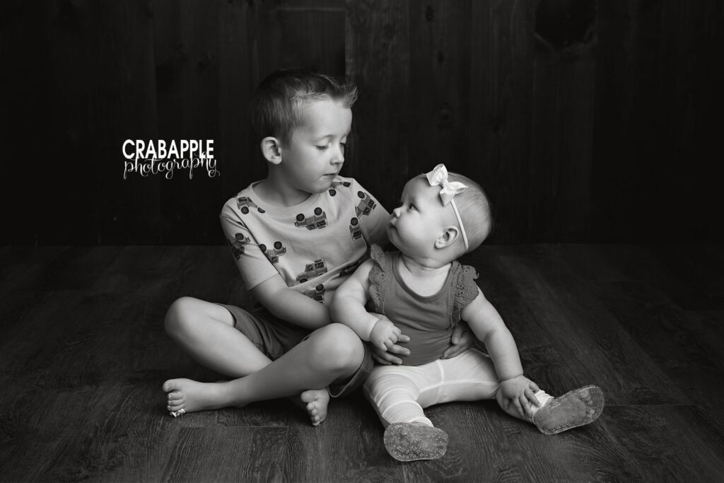 playful sibling baby portrait photography Bedford MA playful sibling portrait during baby milestone photography Bedford MA