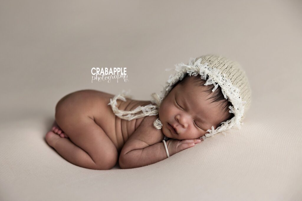 newborn baby softly lit in studio setup
