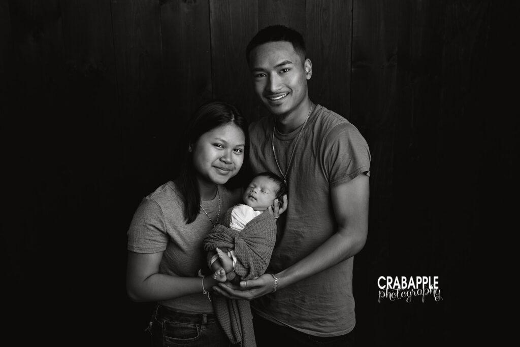black and white portrait of parents with newborn
