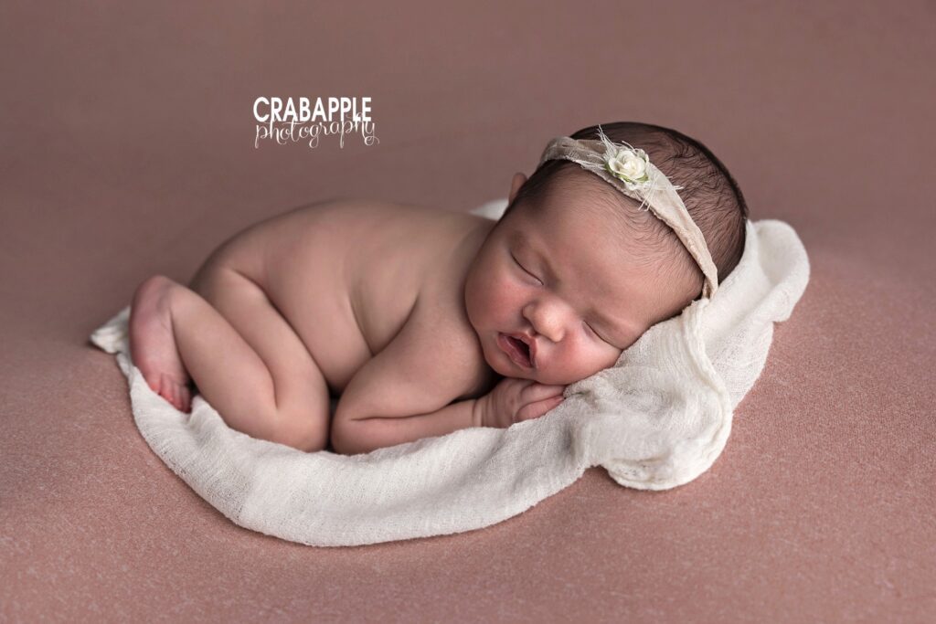 newborn photo ideas baby girl resting on soft pink blanket light airy newborn photography
