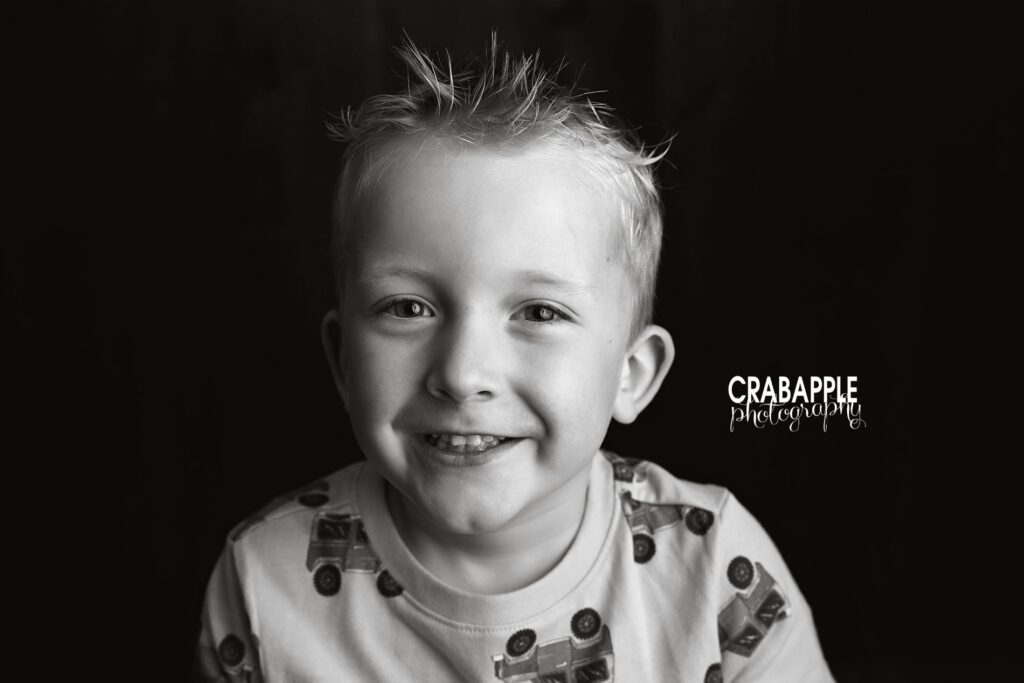 Bedford MA child photographer Close up portrait of older brother during baby portrait photography session in Bedford MA
