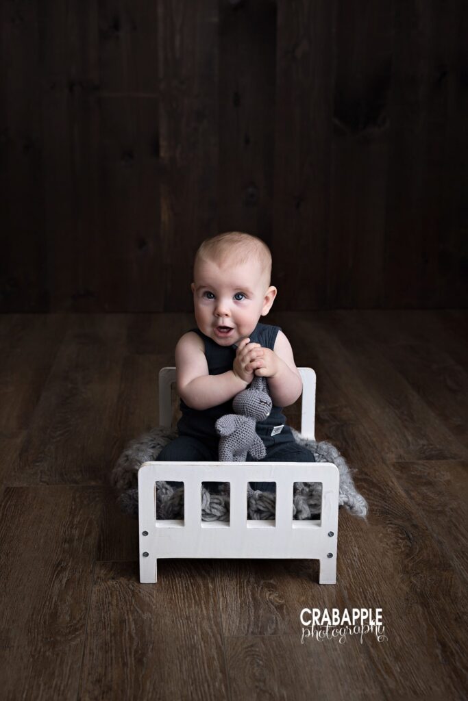 wooden bed prop for baby photos baby sitting on small wooden bed prop studio milestone session