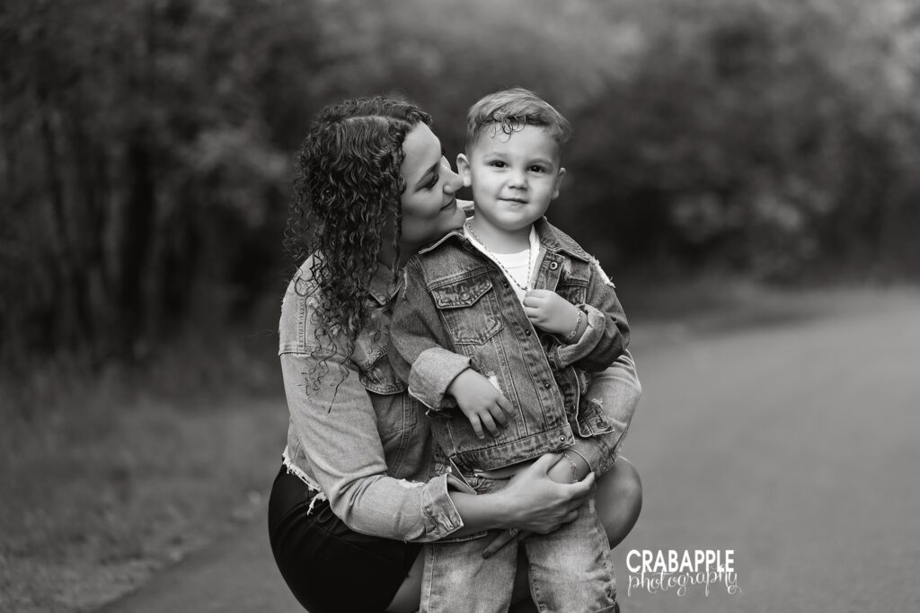 black and white photo of mom holding toddler outdoors
