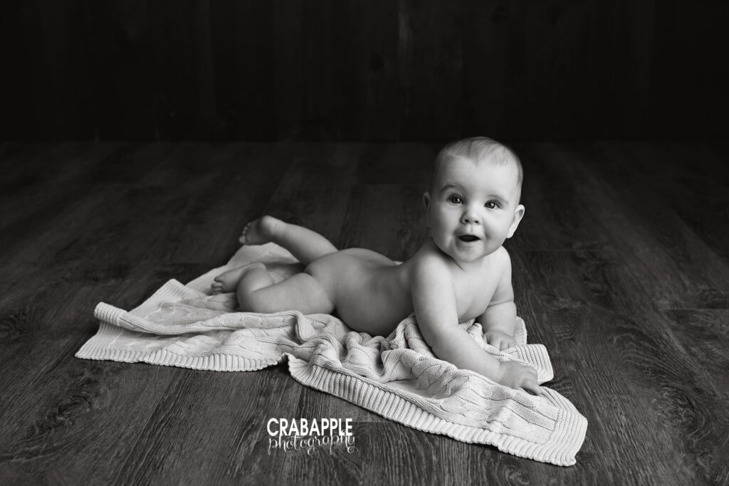 tummy time portrait black and white baby doing tummy time on floor portrait