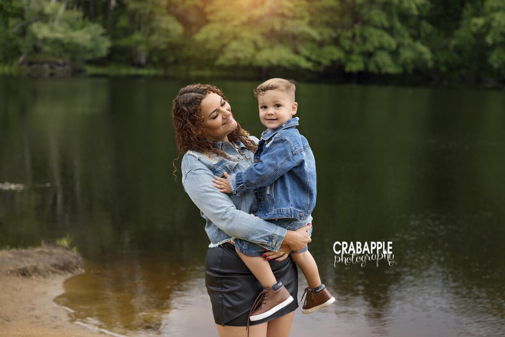 mother holding 3 year old son by water at Ipswich River Park during outdoor child photography session